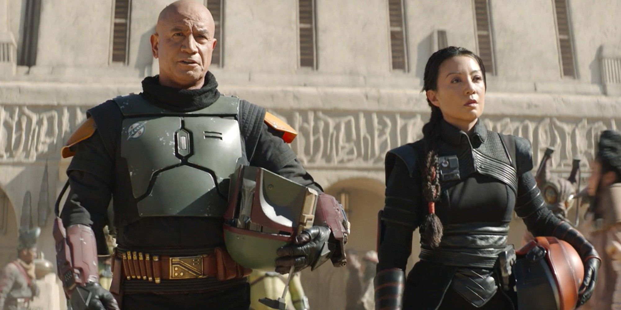 Boba and Fennec standing next to each other with their helmets off in The Book of Boba Fett
