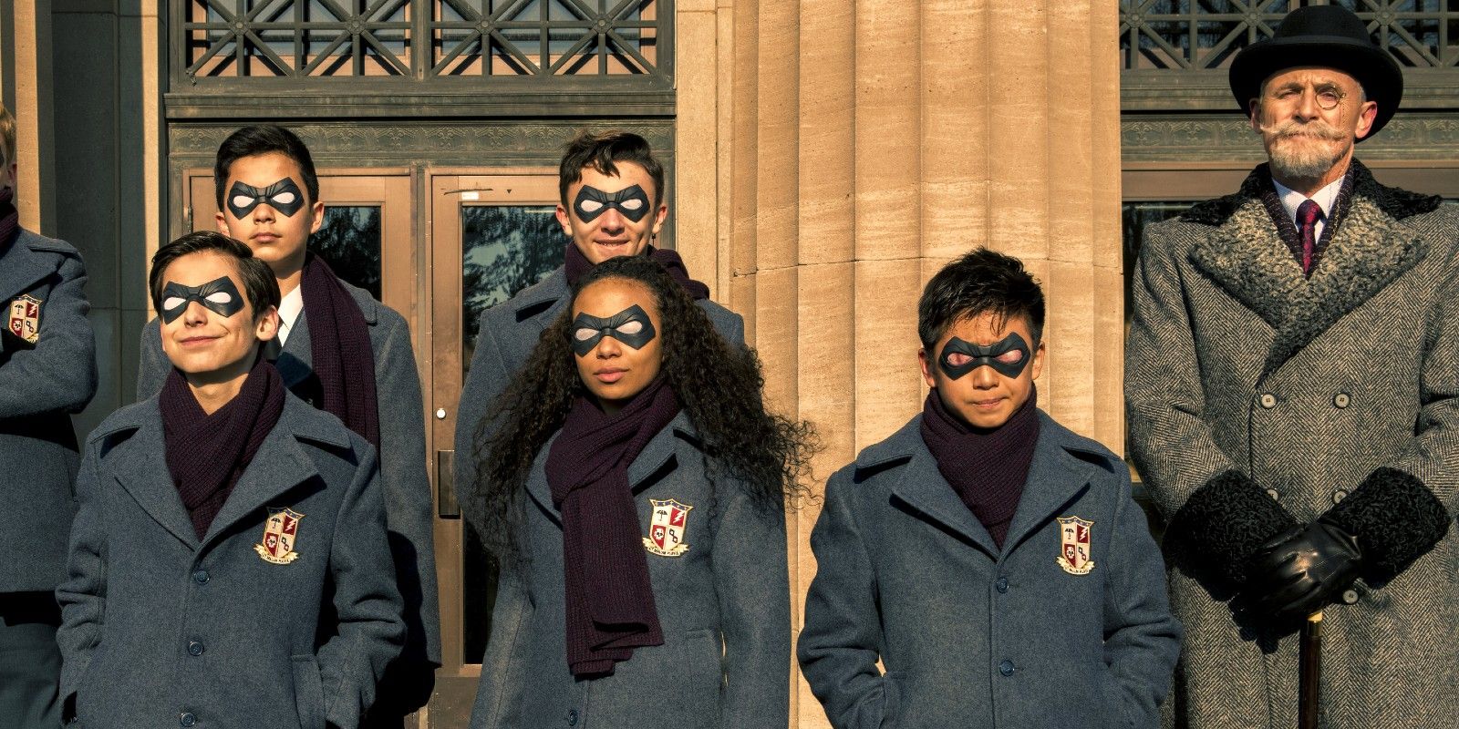 The Umbrella Academy as children with their father