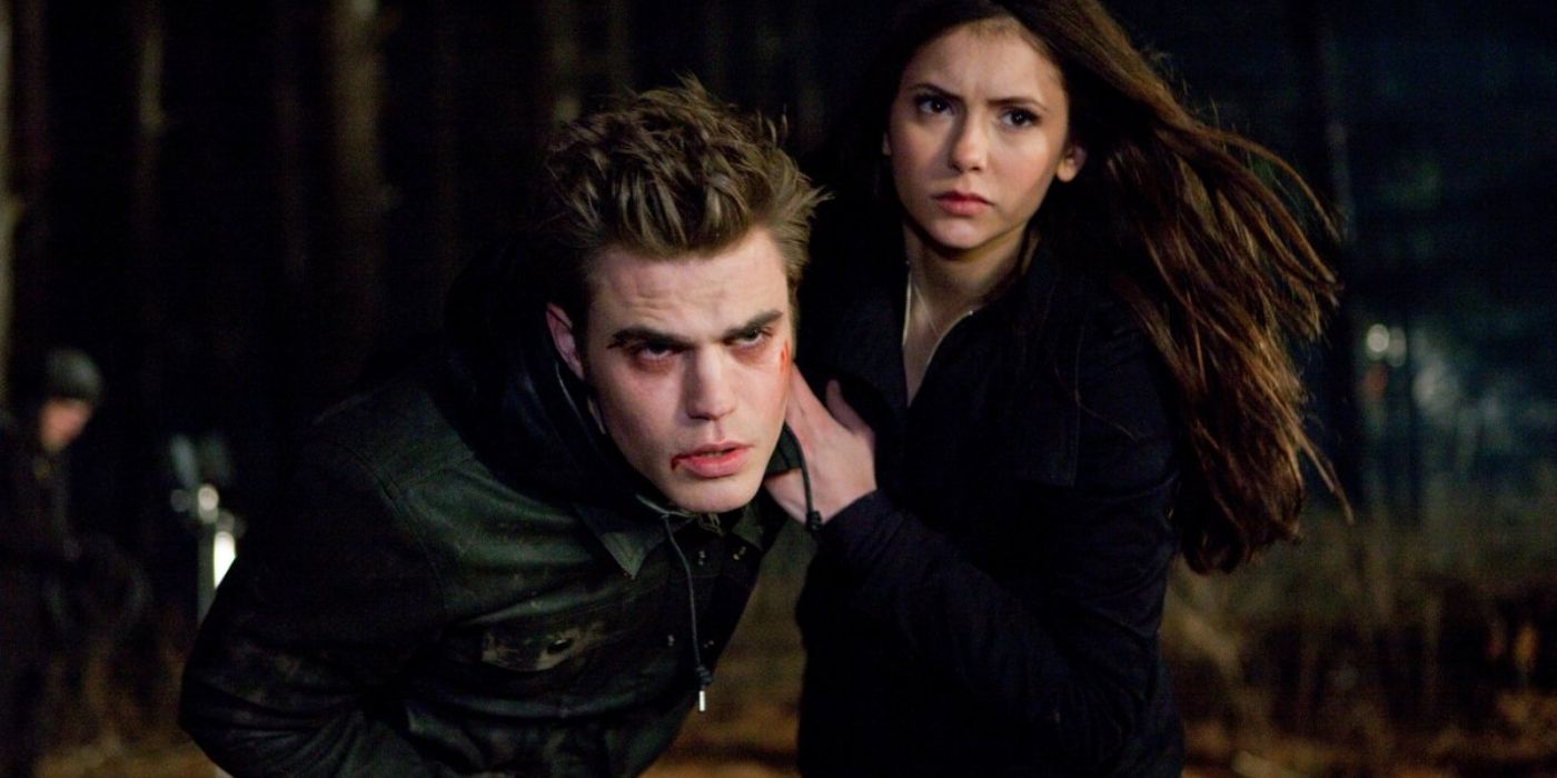 Stefan with blood on his face and Elena outside on The Vampire Diaries