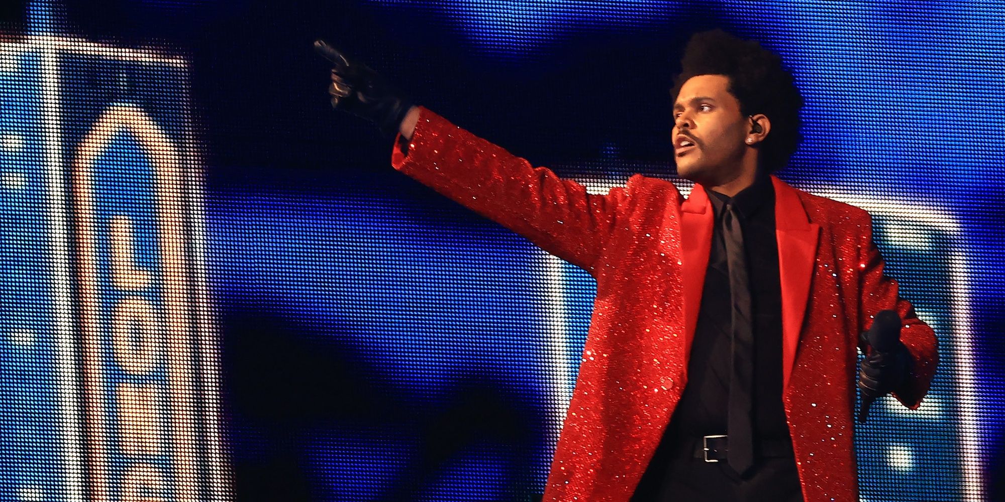 The Weeknd raising an arm in a still from The Show