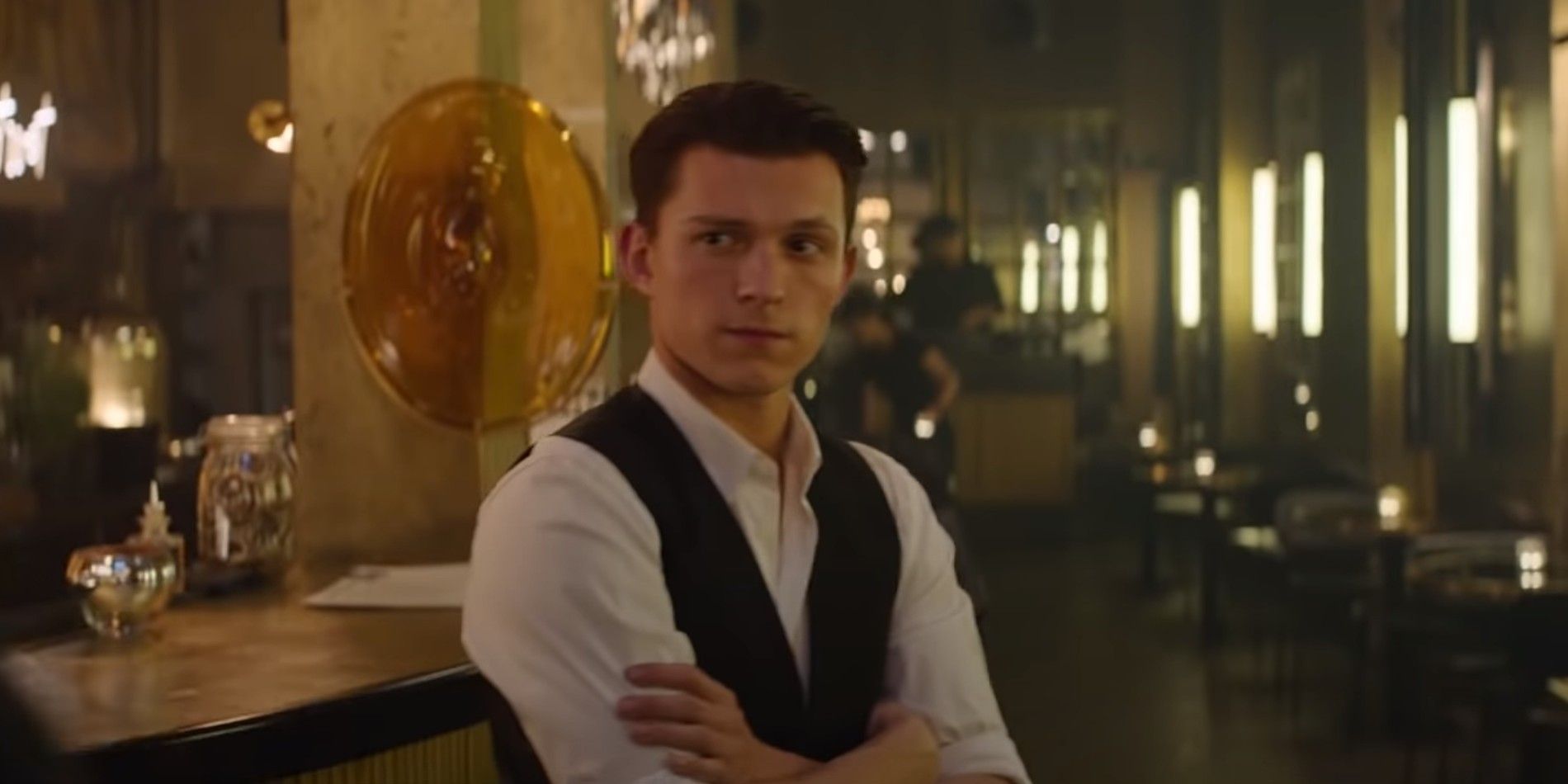 Tom Holland standing behind a bar in Uncharted