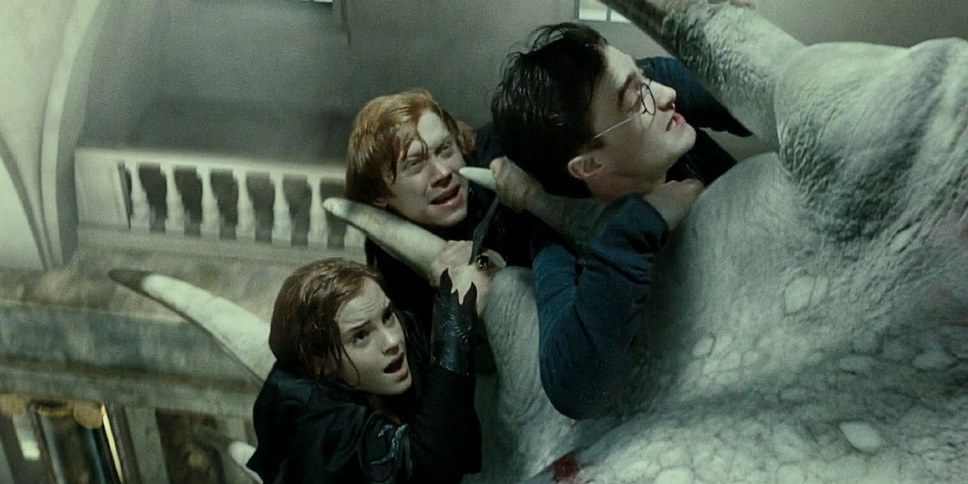 Hermione, Ron, and Harry holding on to the dragon in Harry Potter and the Deathly Hallows Part 2.