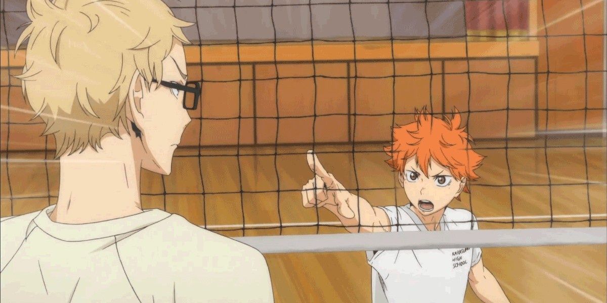 Hinata points at Tsukishima intensely. There is a volleyball net between them.