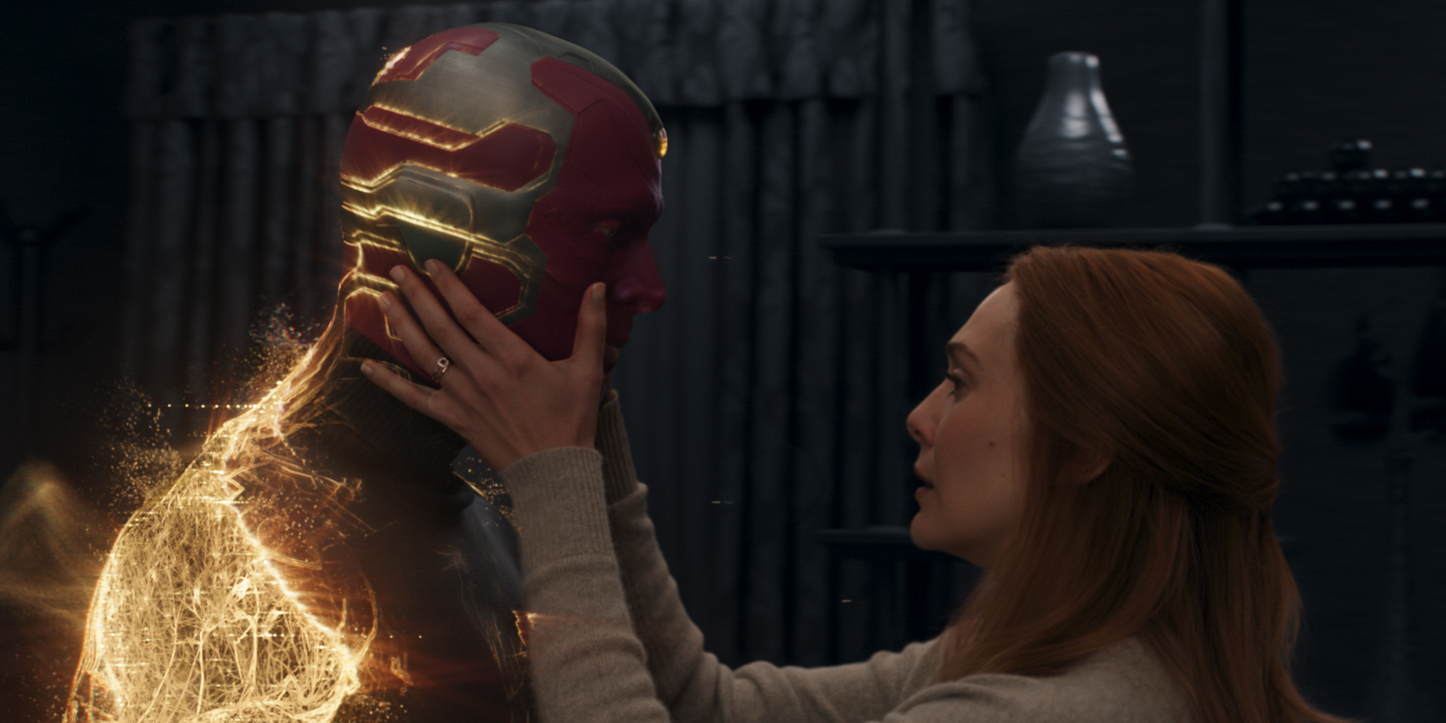 Wanda holding Vision as he disappears