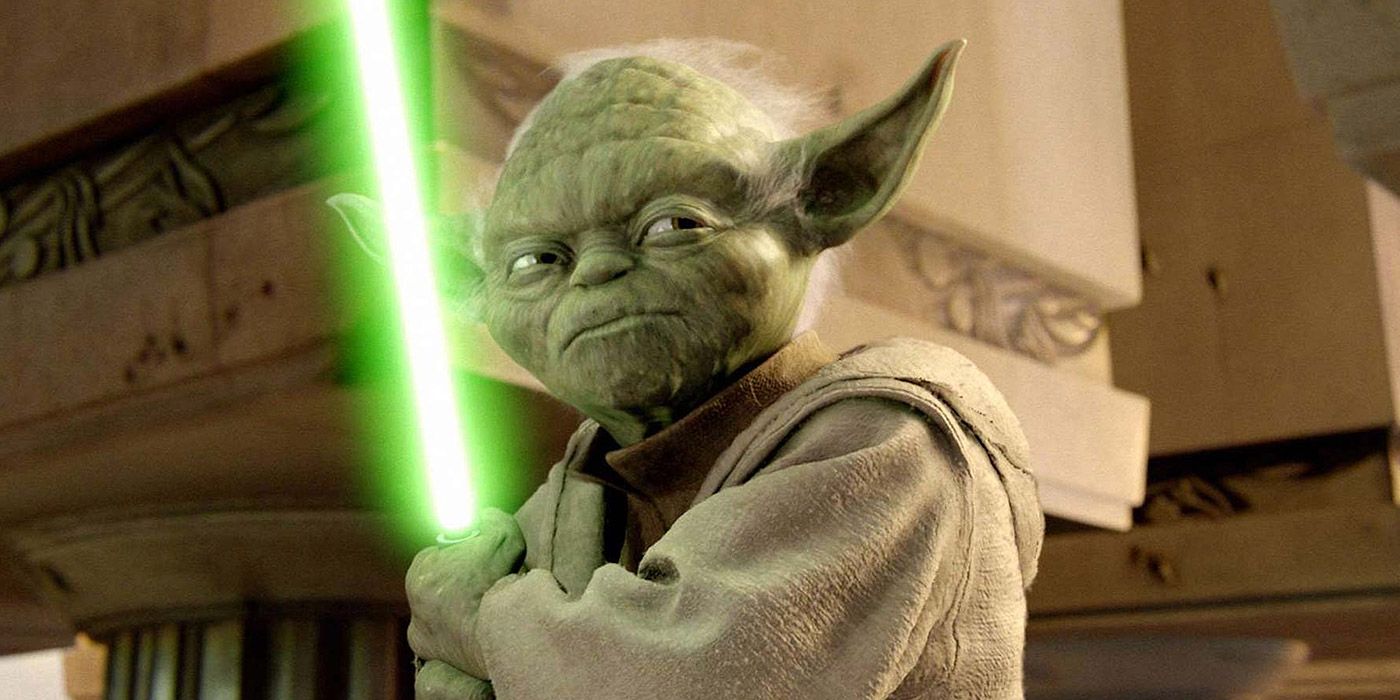 Yoda holding his lightsaber in Star Wars