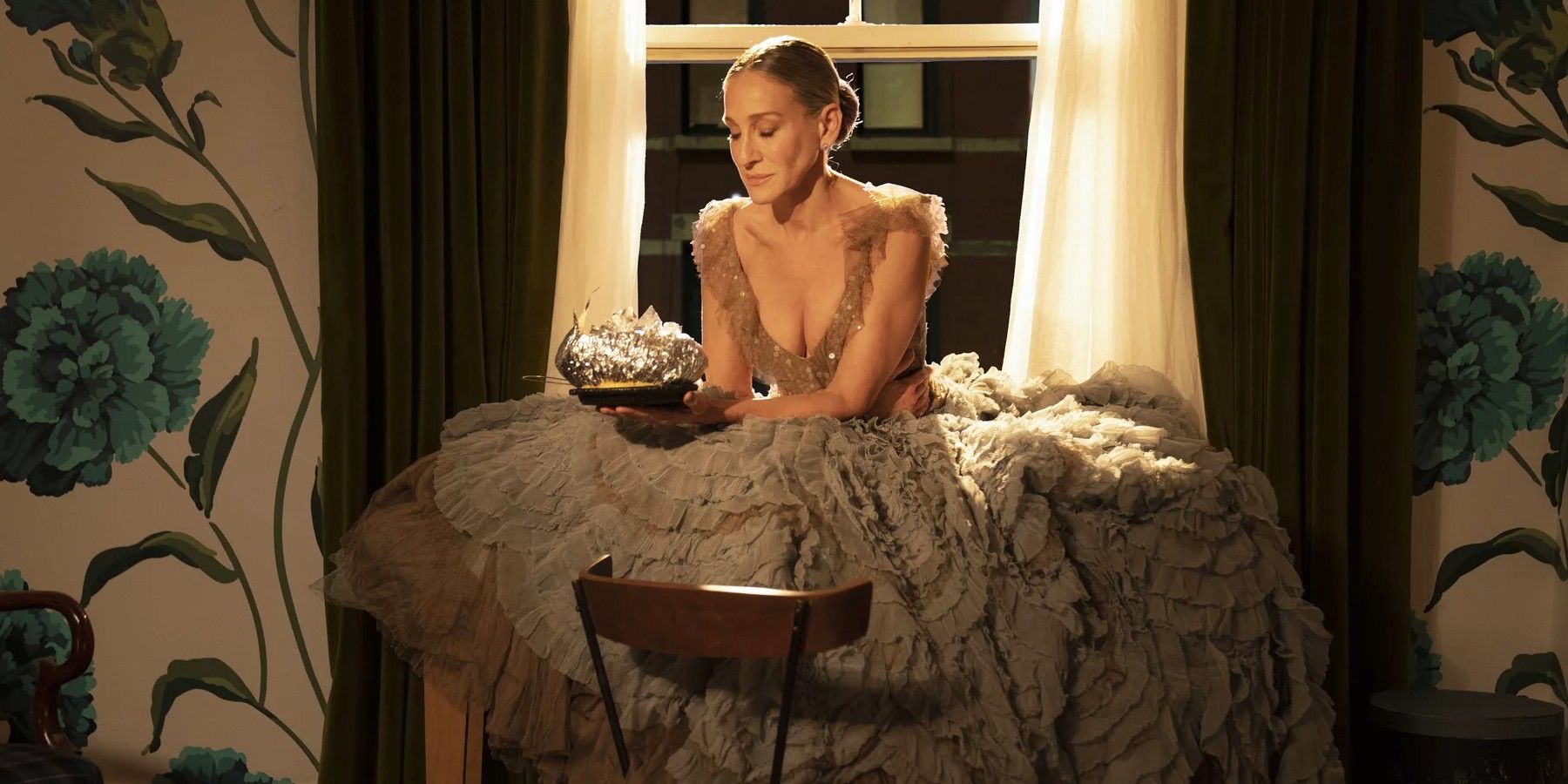 Carrie in her Versace dress eating by the window in And Just Like That