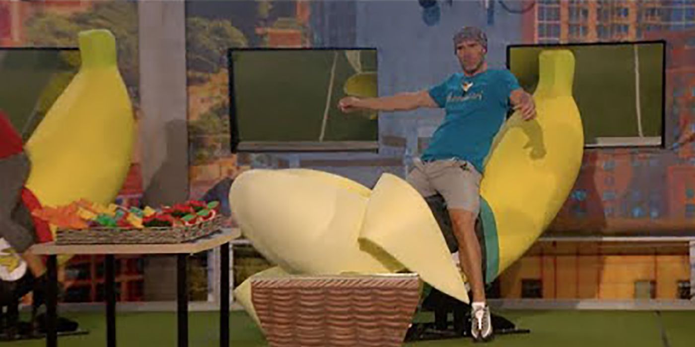 Enzo riding a giant banana during a competition on Big Brother.