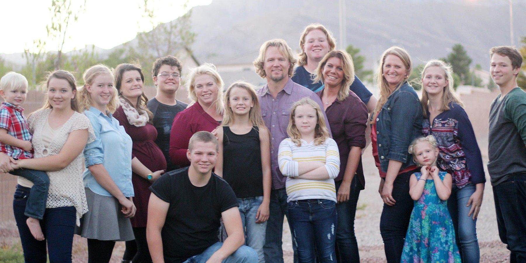 brown family with kids Sister Wives group shot taken outside CROPPED