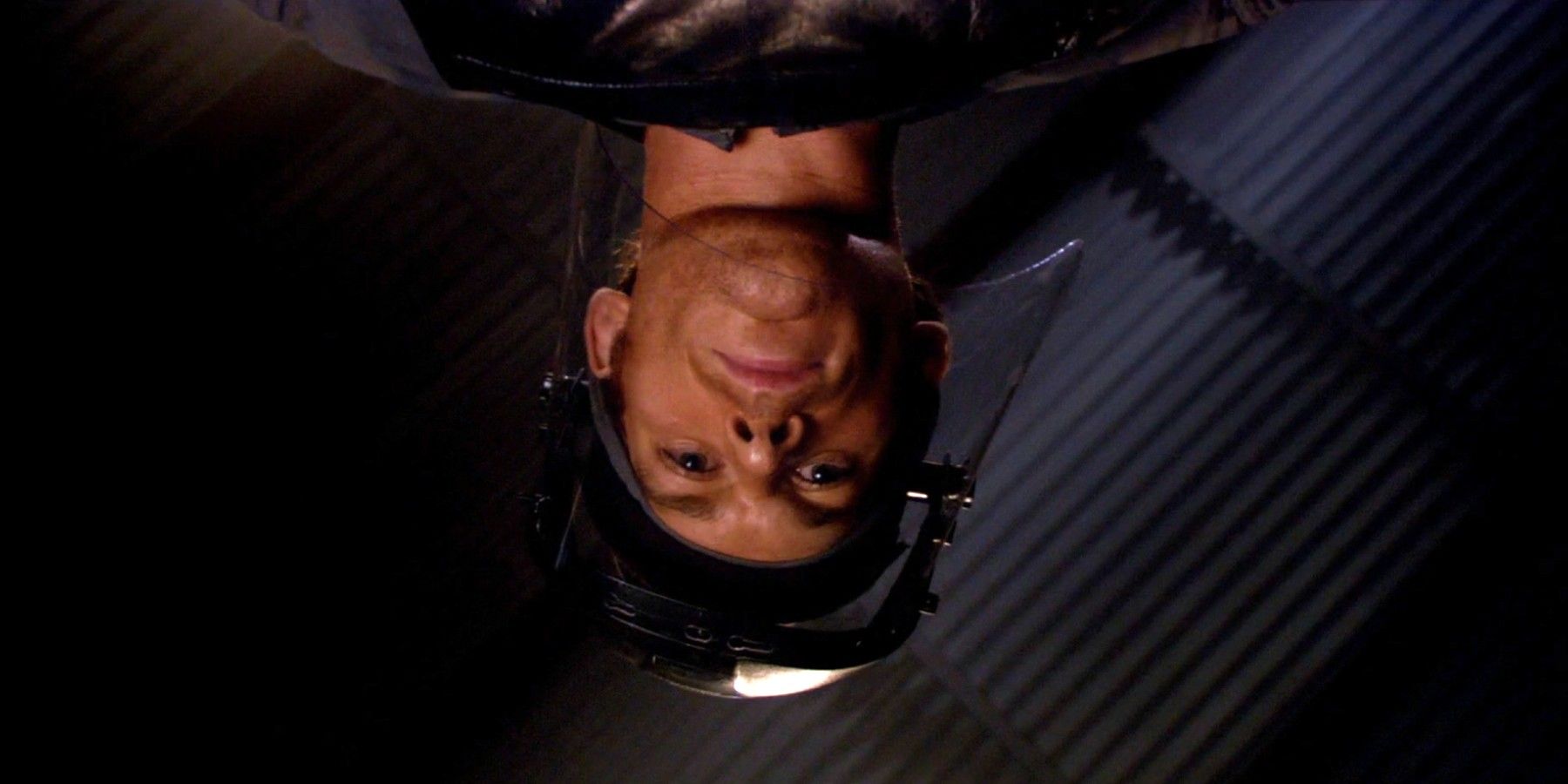 An image of Dexter looking down at the table in Dexter