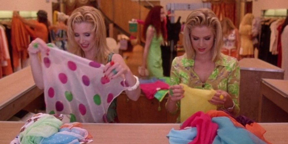 Romy and Michele fold scarves.