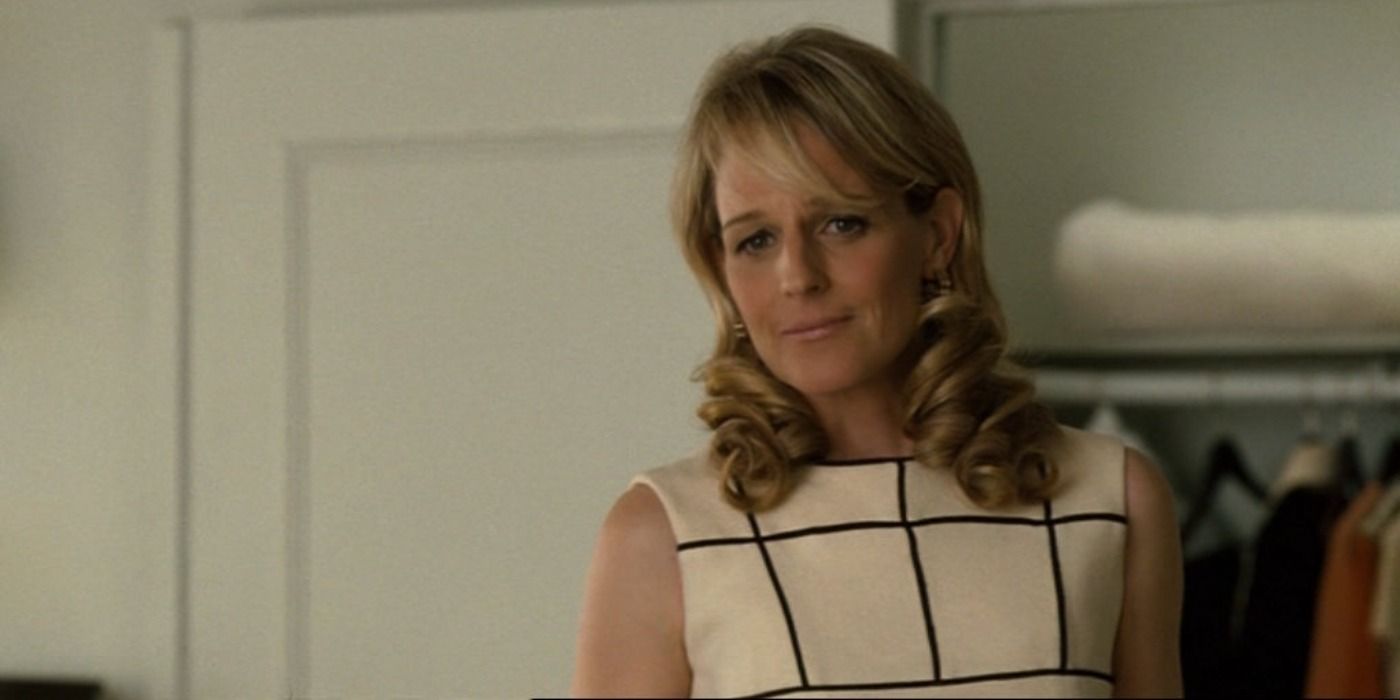 Helen Hunt wearing a white dress with curly hair looking concerned in Bobby.