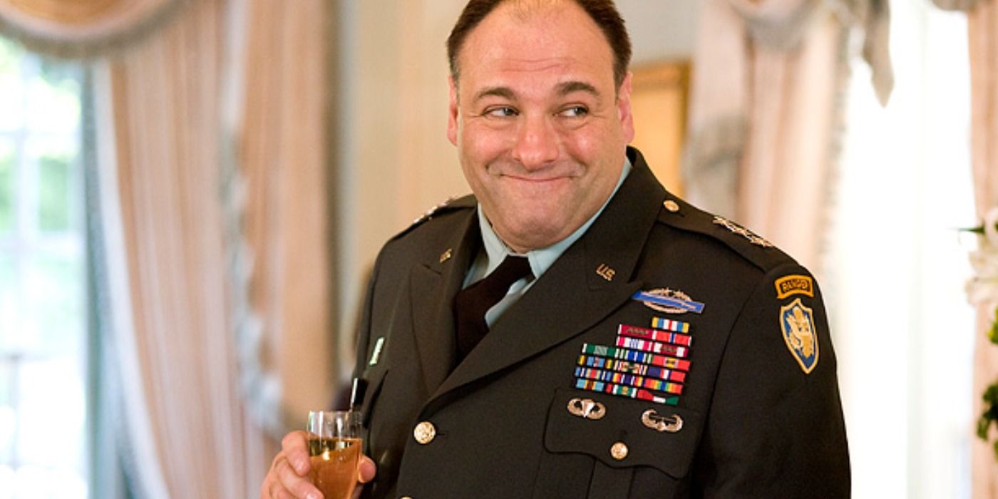 James Gandolfini dressed as military holding a glass of champagne in Out Of The Loop.