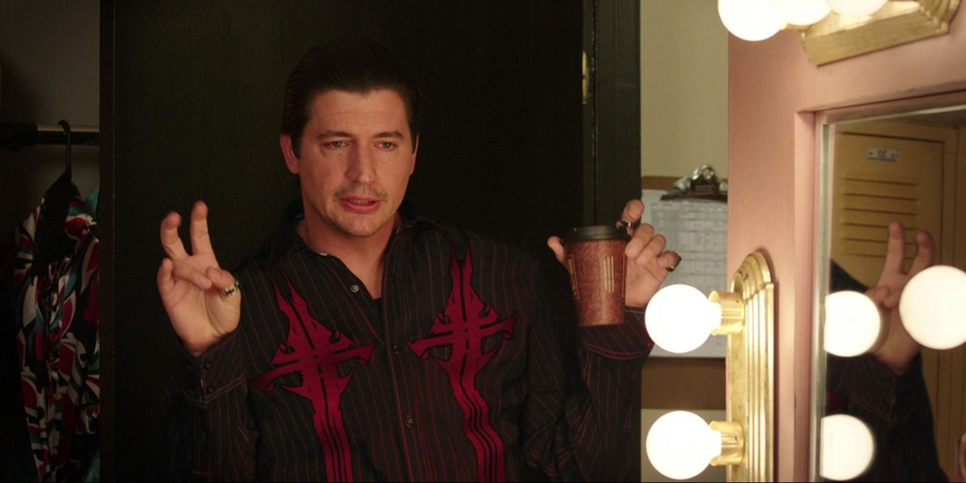 Ken Marino with slicked back hair in front of a mirror in We're The Millers.