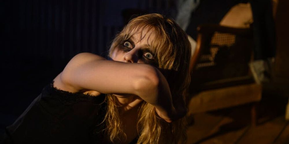 Ellie covers her face in terror in Last Night in Soho