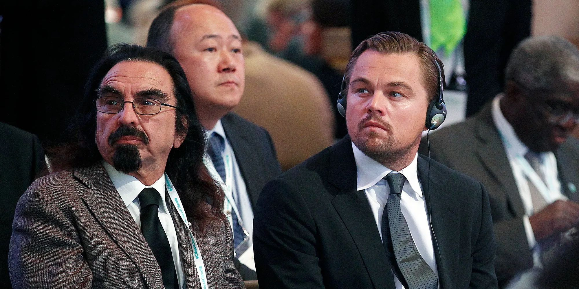 Leonardo and George DiCaprio sitting at an event