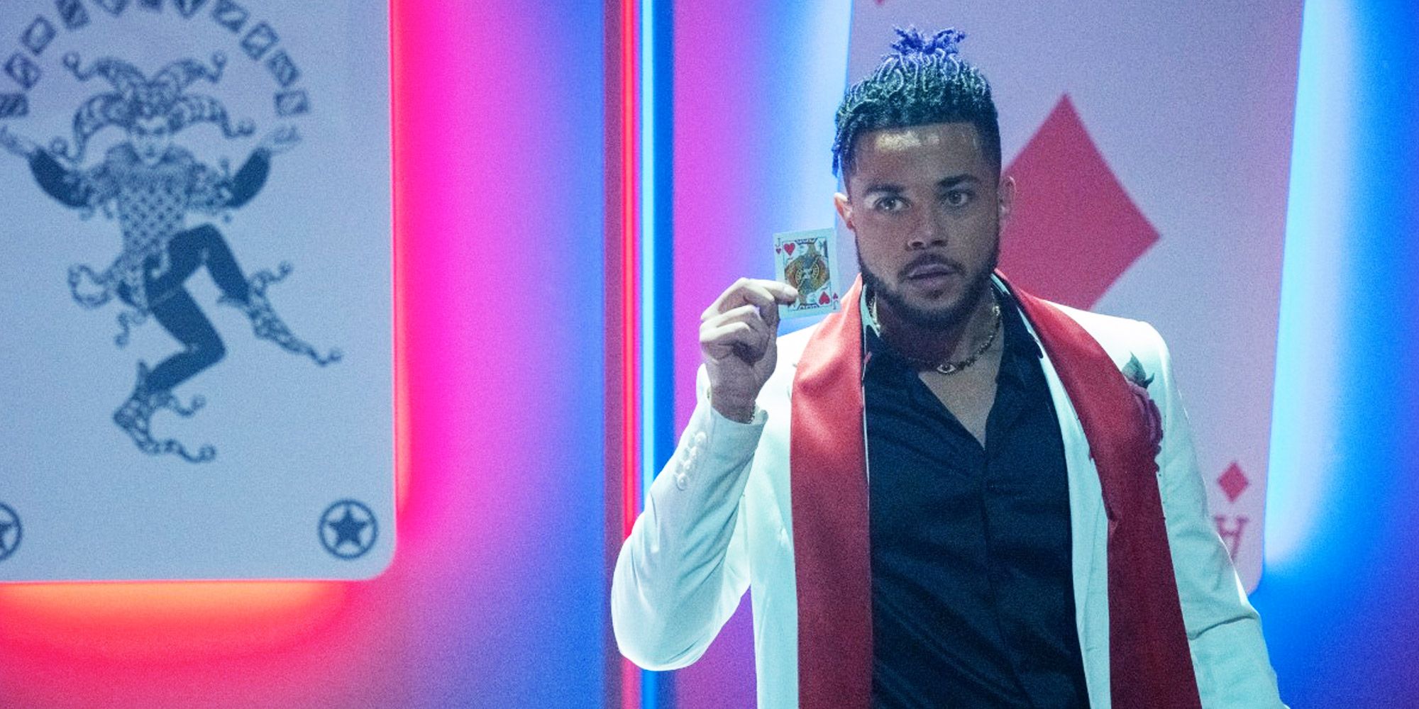 Marquis holds up a playing card in Batwoman