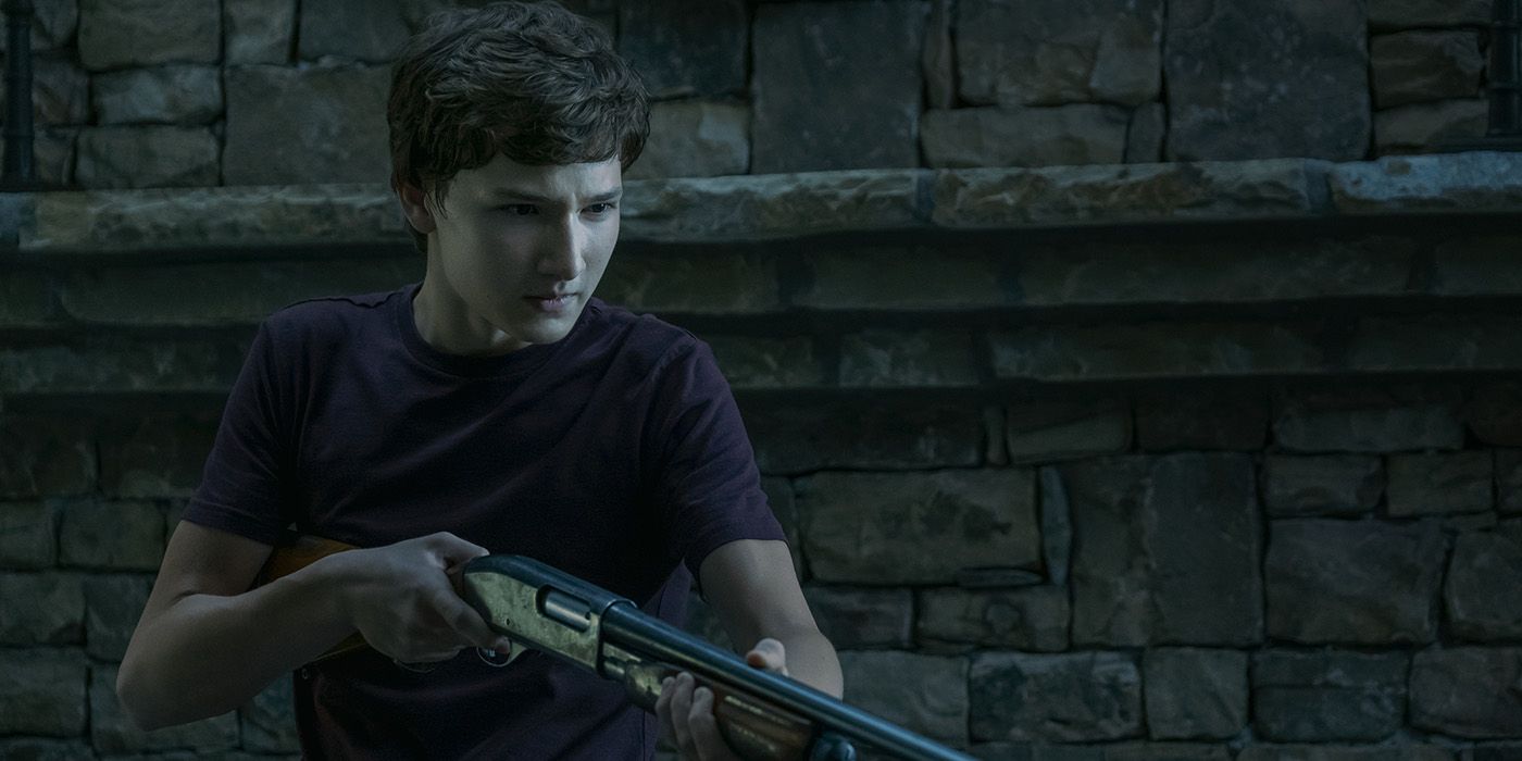 Jonah from Ozark holding a gun, looking scared.