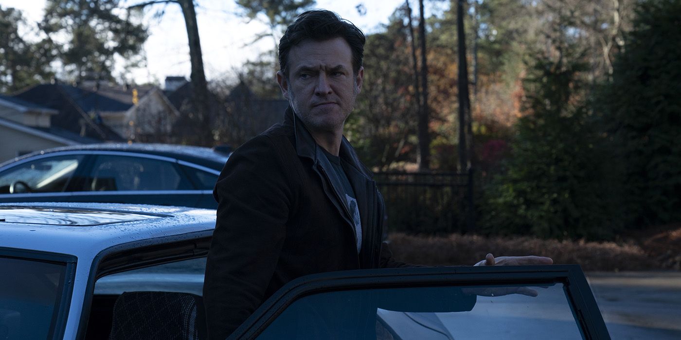 Mel standing by his car looking at something in a scene from Ozark.