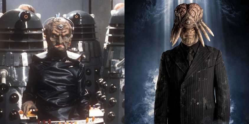 Davros is surrounded by Daleks, as Dalek Sec Hybrid stands in front of a blue backdrop.