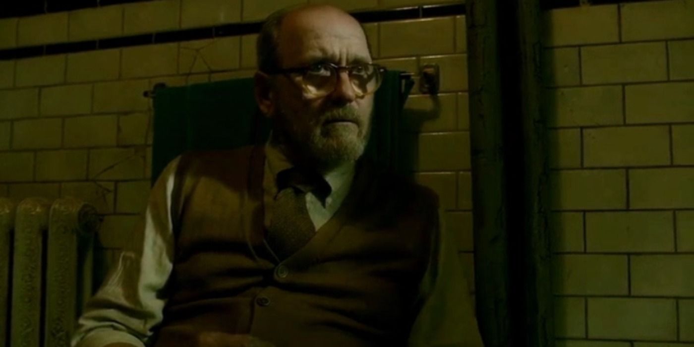 Richard Jenkins wearing glasses and staring in The Shape of Water.