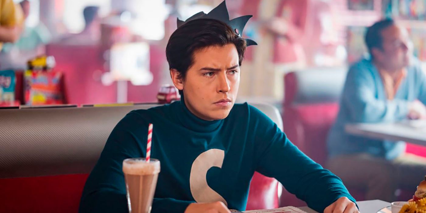 Jughead at Pop's wearing an Archie Comics Jughead whoopee cap and wearing a green Shirt with an S on the front from Riverdale.