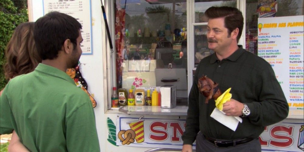 Ron eats &quot;The Swanson&quot; in front of a food truck in Parks &amp; Recreation.