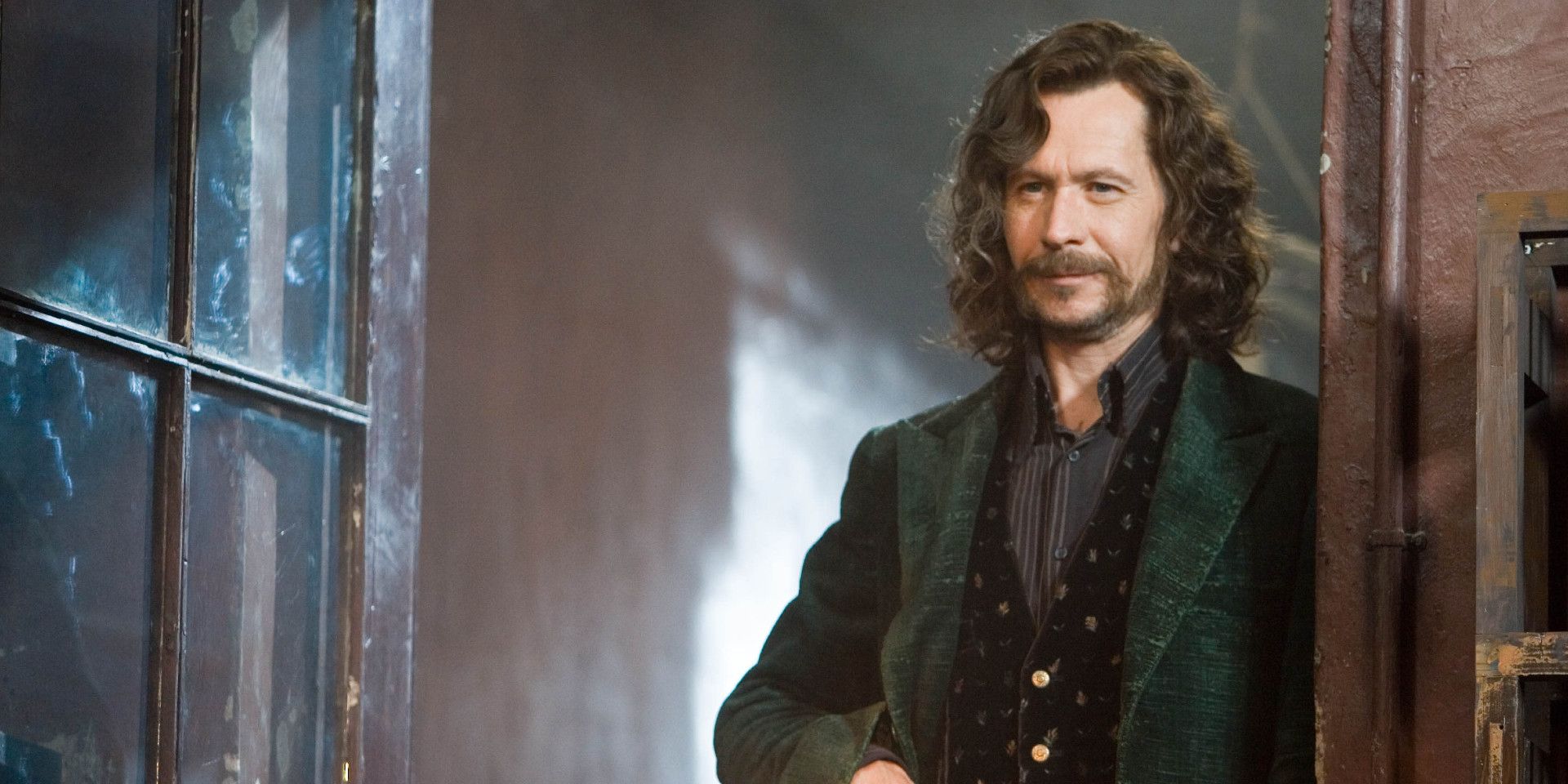 Sirius Black standing in doorway with a cocky smile in Harry Potter