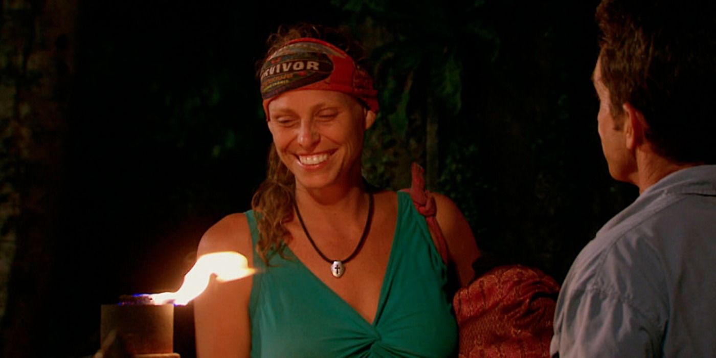 Kimmi Kappenberg smiling as Jeff snuffs her torch on Survivor