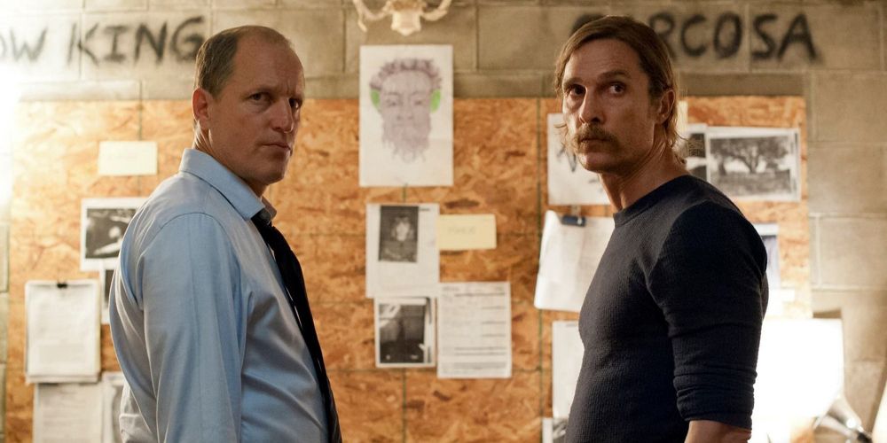 Rust and Marty stand across from each other in the investigation room on True Detective