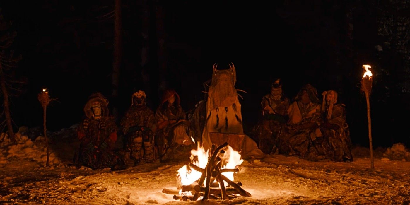 Veiled characters sit around a campfire in Yellowjackets.