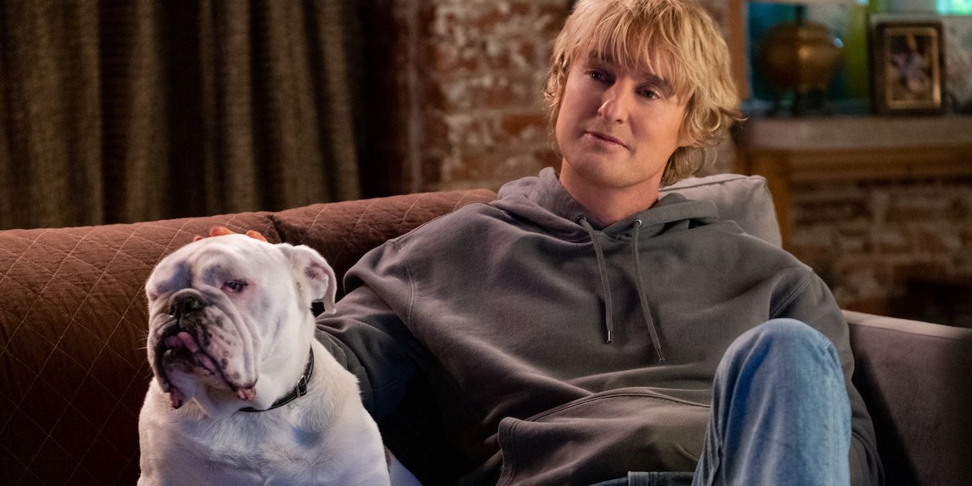 Charlie sitting on the couch with a dog in Marry Me