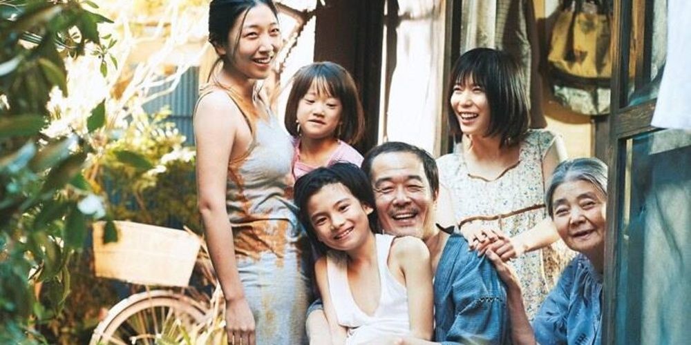 A family laughs together outside their house in Shoplifters Cropped 1