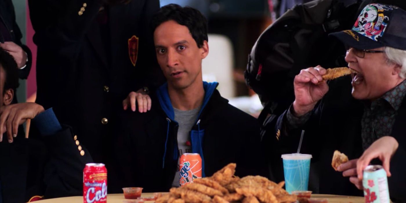 Abed sitting at a table in Community.
