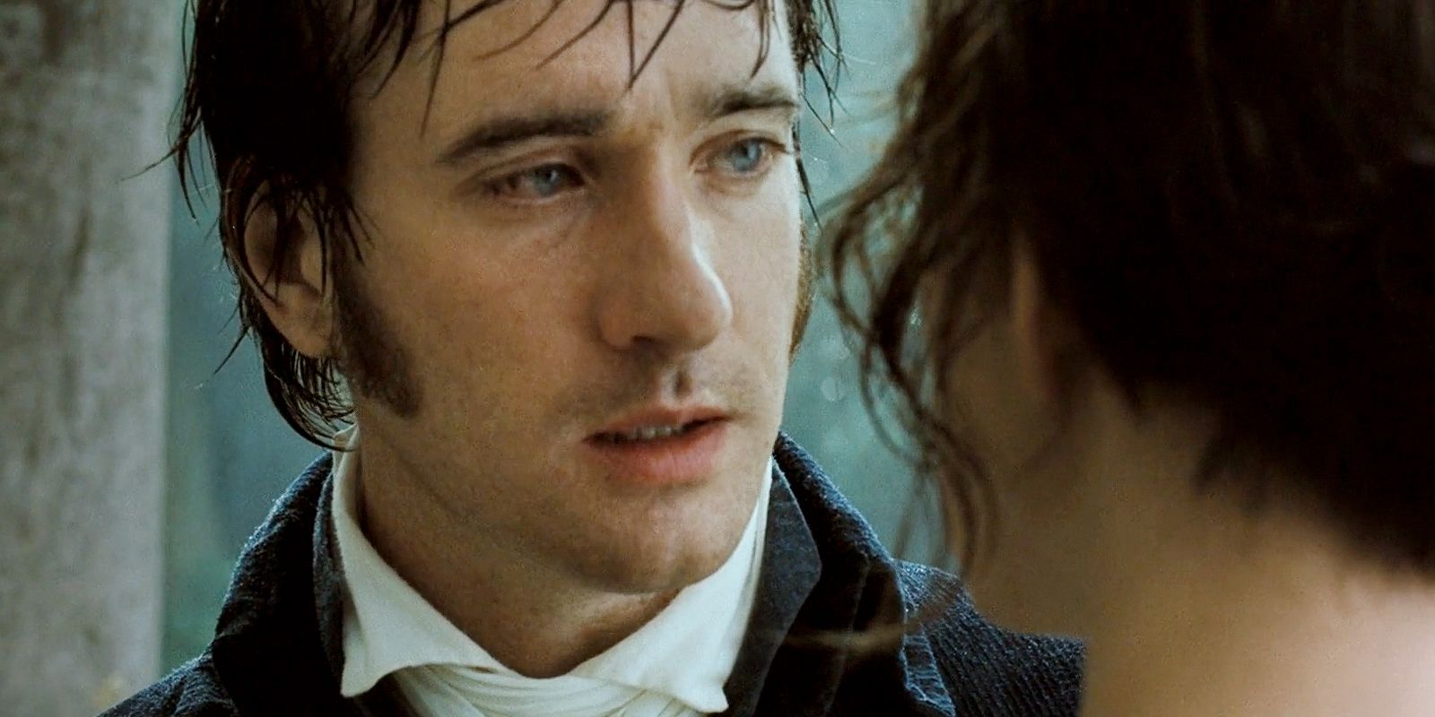 Mr. Darcy and Elizabeth look at each other in the rain scene in Pride & Prejudice, almost kissing.