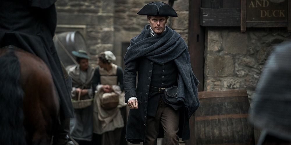 An image of Jamie walking through a town in Outlander