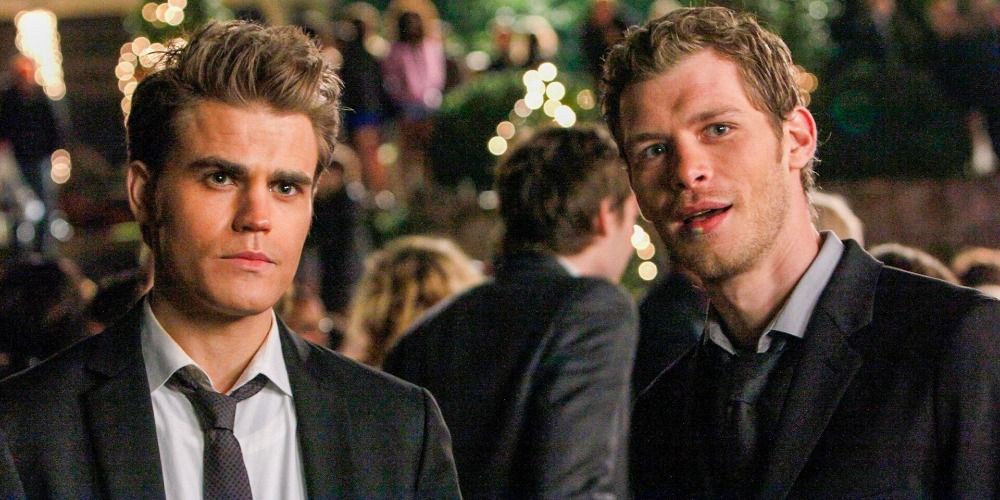 An image of Klaus and Stefan looking concerned at the dance in The Vampire Diaries