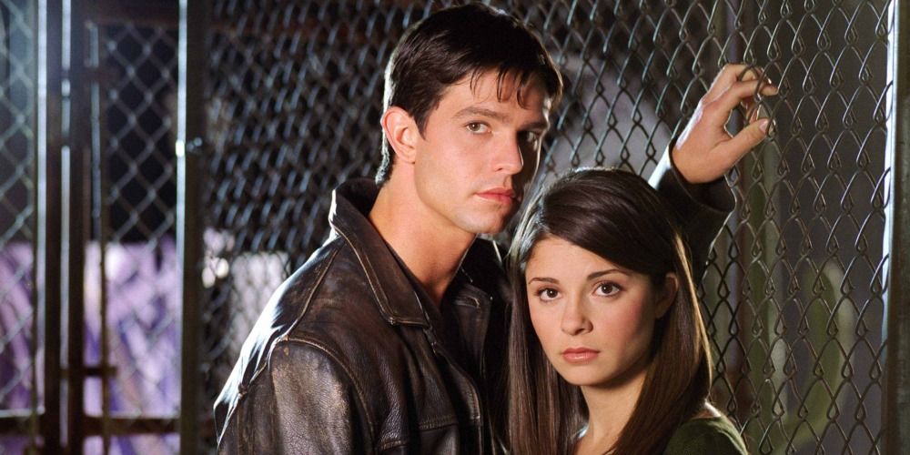 An image of Max and Liz standing next to a fence in Roswell