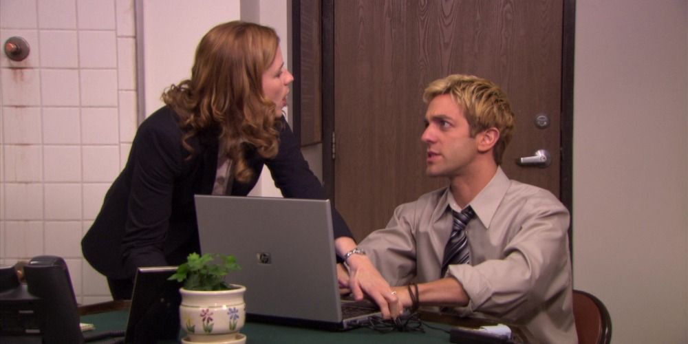An image of Pam and Ryan fighting over a laptop in The Office