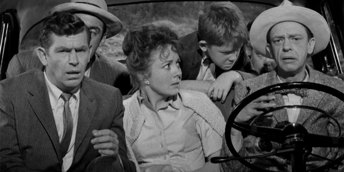 Barney looks concerned as a group of passengers look on from Barney's First Car