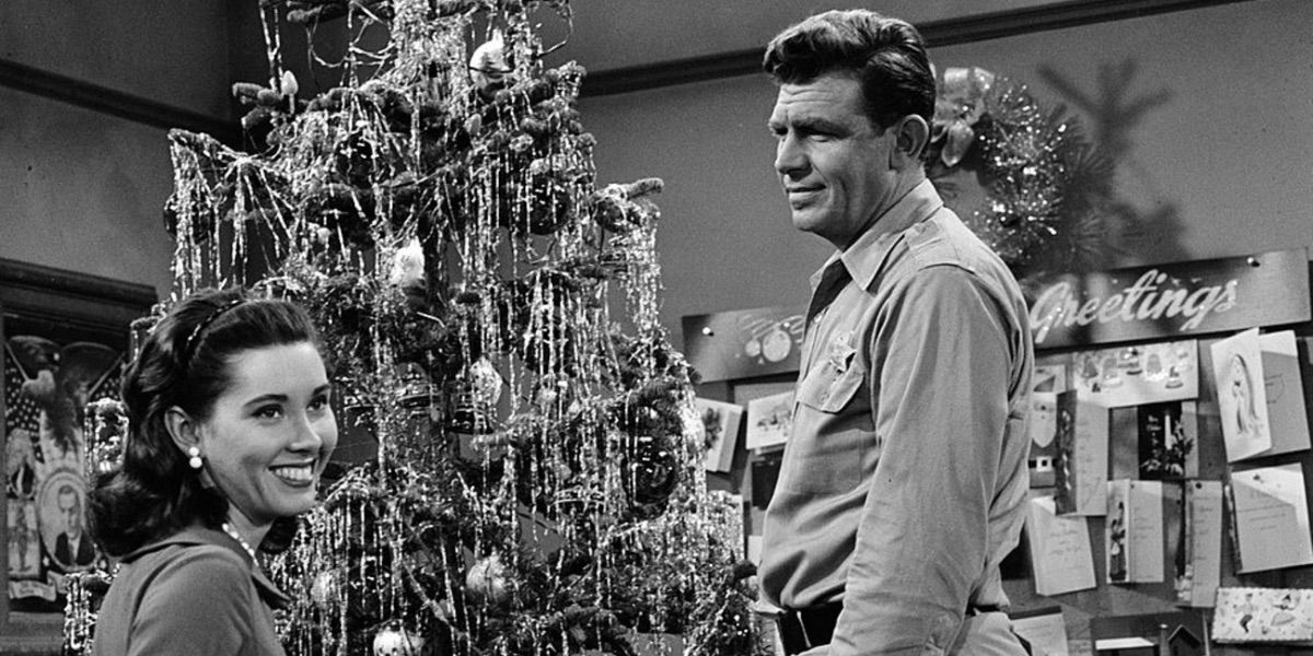 Andy Taylor looks on as a woman decorates a Christmas tree from Christmas Story