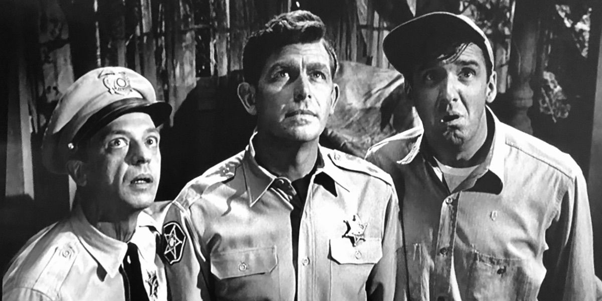 Barney, Andy, and Gomer look on nervously from The Haunted House