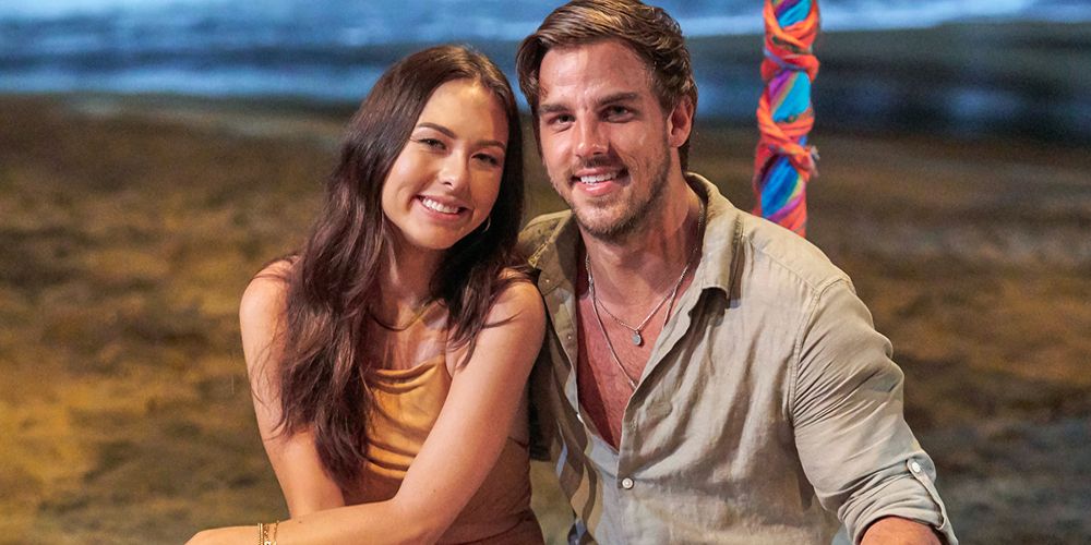Abigail and Noah sit together in the sand on Bachelor in Paradise