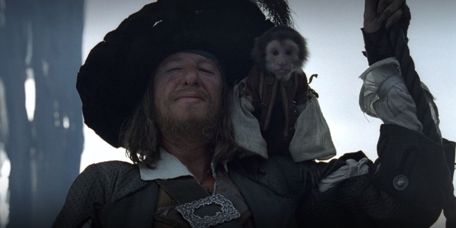 Barbossa with Jack the monkey on his shoulder in Pirates Of The Caribbean Curse Of The Black Pearl