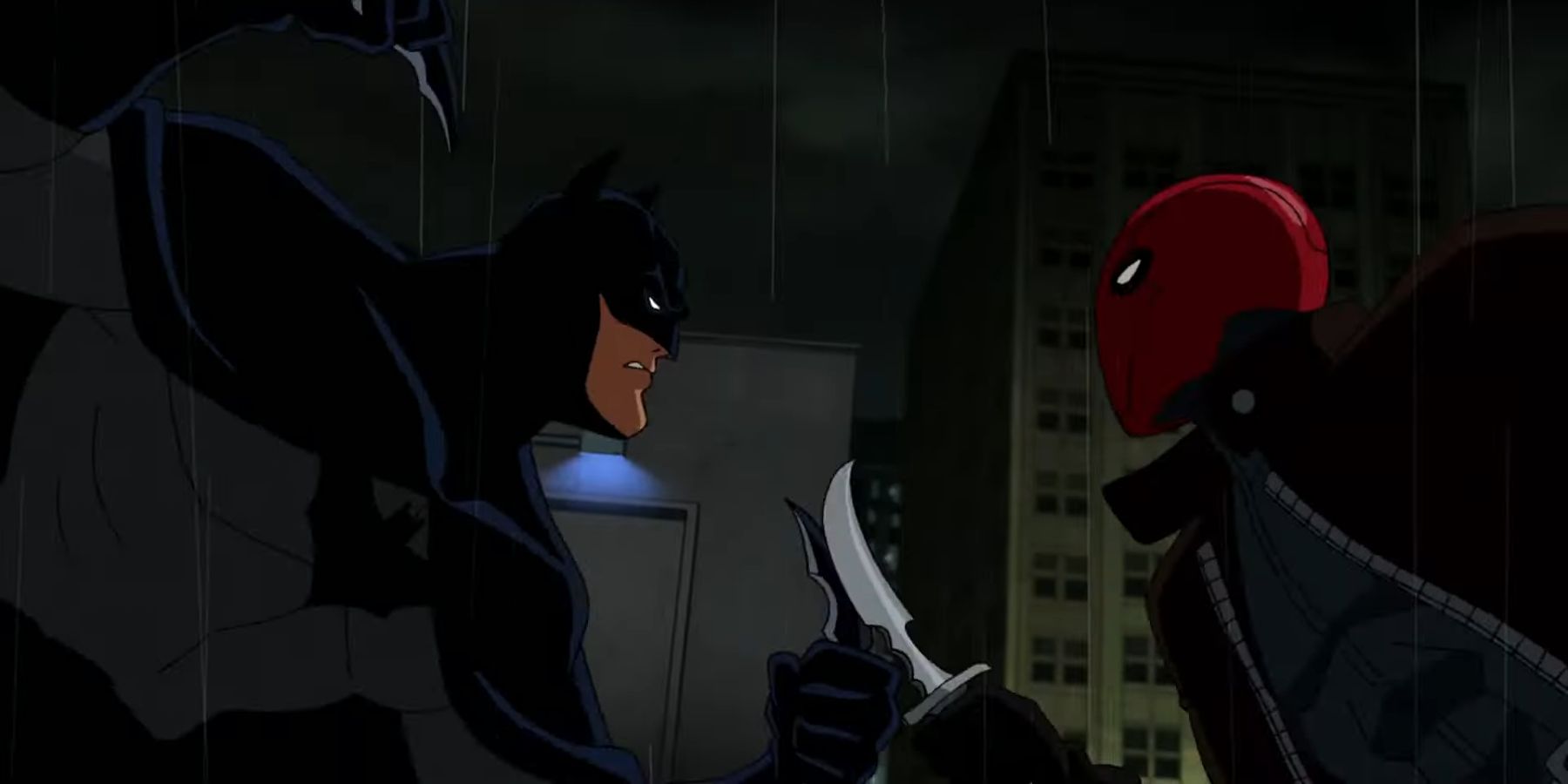 Batman and the Red Hood battling on a rooftop in Batman Under The Red Hood