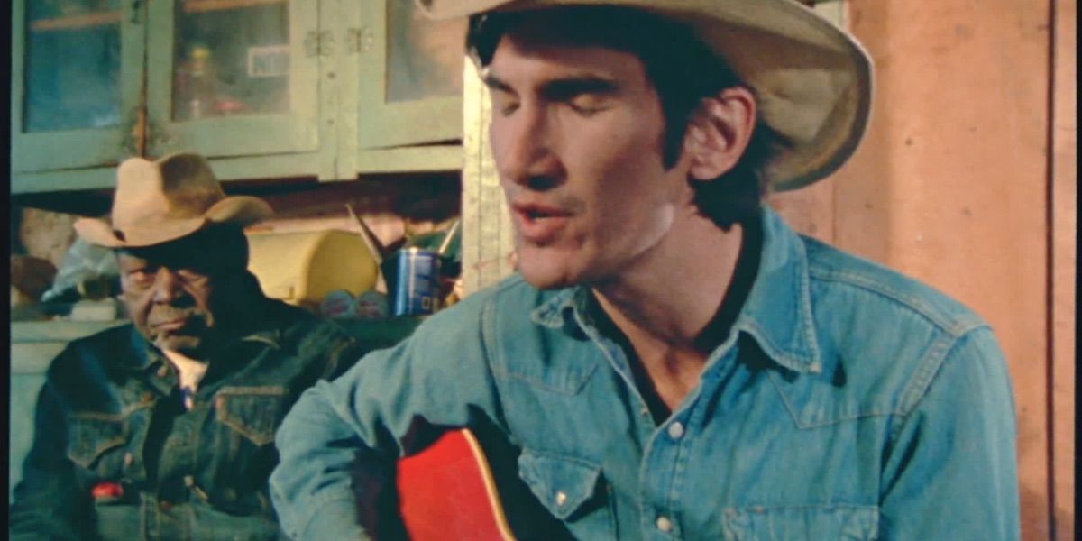Townes Van Zandt sings while a man listens from Heartworn Highways 