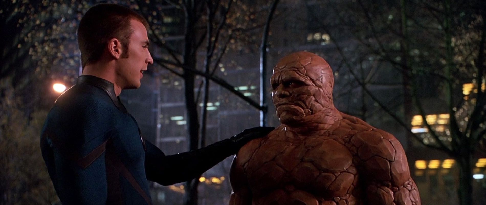 Johnny Storm (Chris Evans) puts his arm on the shoulder of Ben Grimm (Michael Chiklis) in Fantastic Four