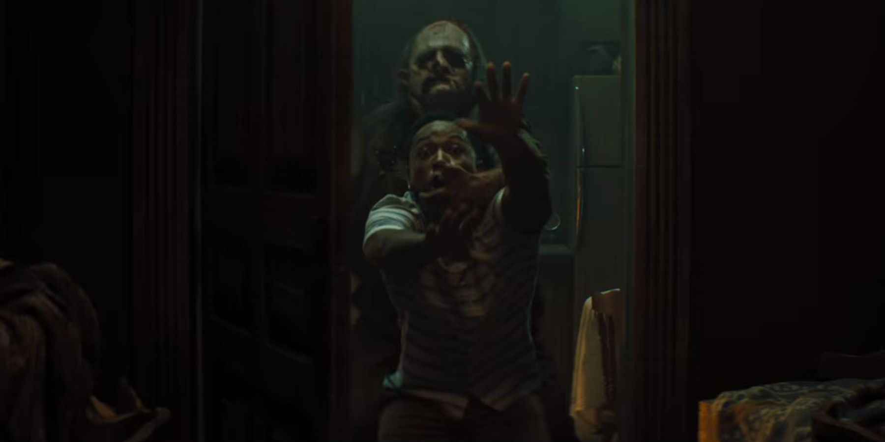 Leatherface pulling Dante into the kitchen in Texas Chainsaw Massacre 2022