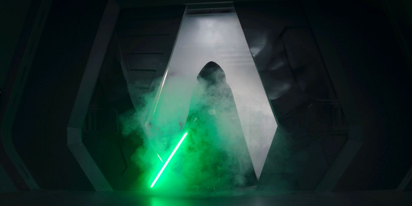 Luke Skywalker silhouetted in his cloak with his lightsaber ignited in The Mandalorian