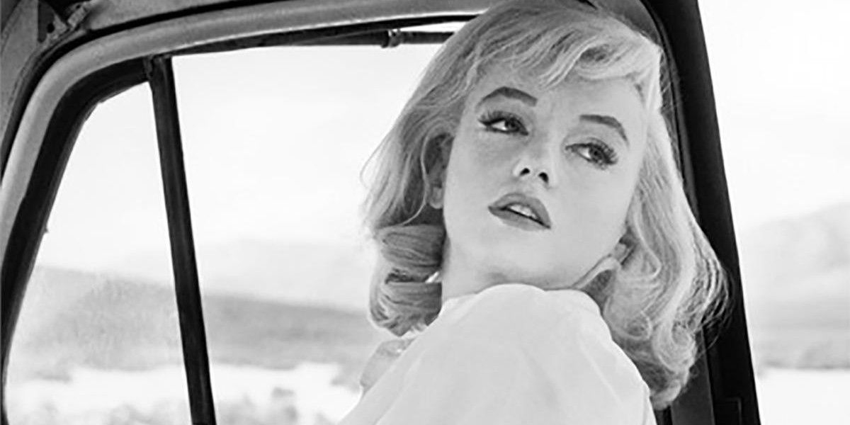 Marilyn Monroe in a car looking over her shoulder in The Misfits