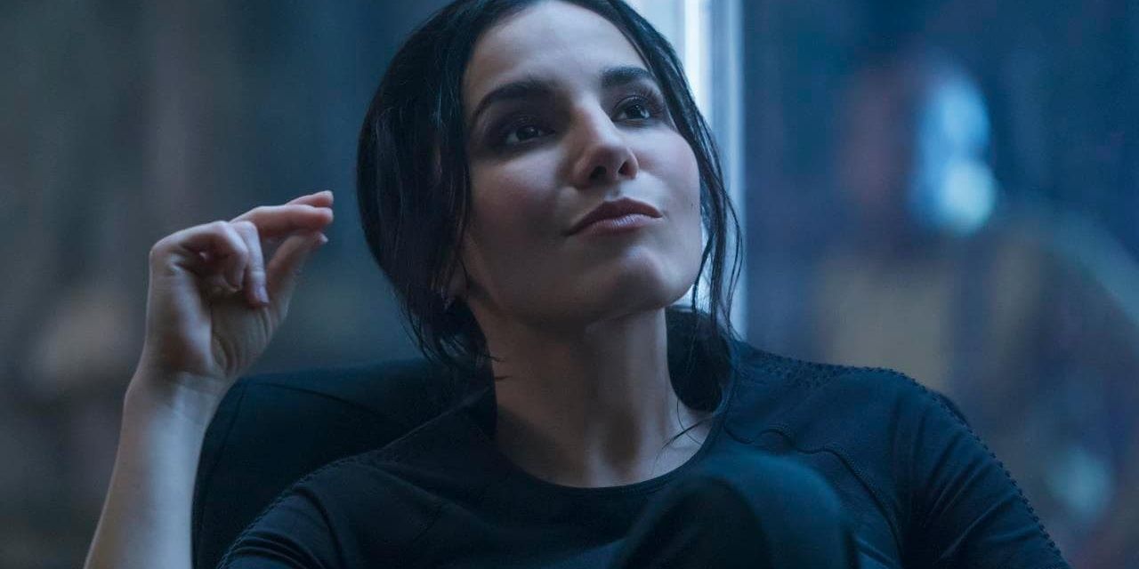 Martha Higareda smirks and looks up in Altered Carbon
